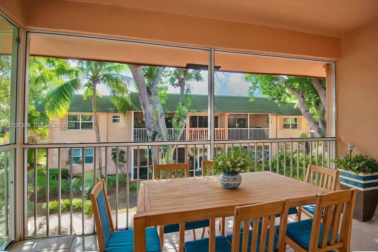 Screened lanai featuring an aluminum-framed enclosure and metal railings