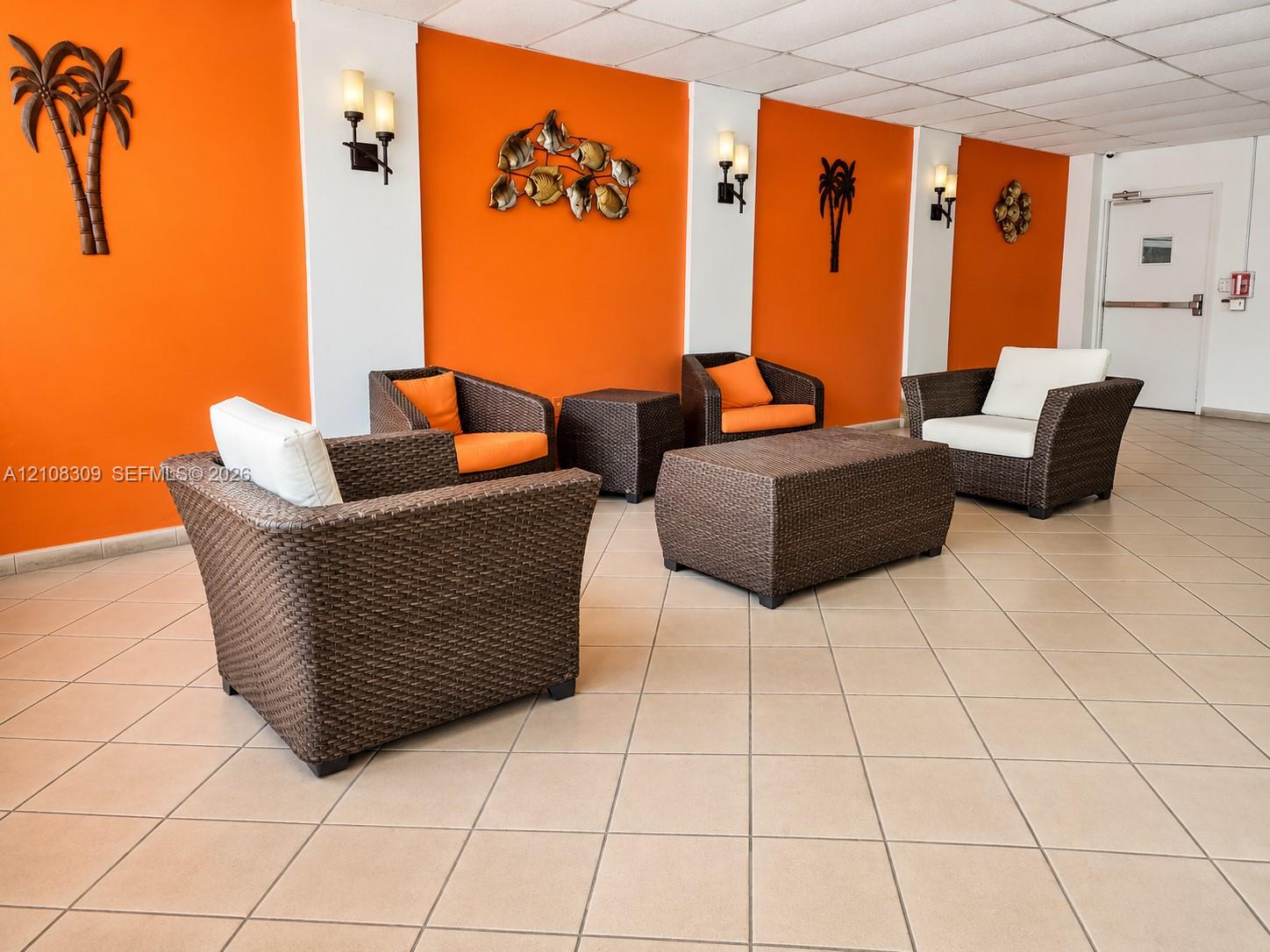 Common area featuring ceramic tile flooring, neutral wall accents, and wall-mounted light fixtures Common area featuring ceramic tile flooring, neutral wall accents, and wall-mounted light fixtures