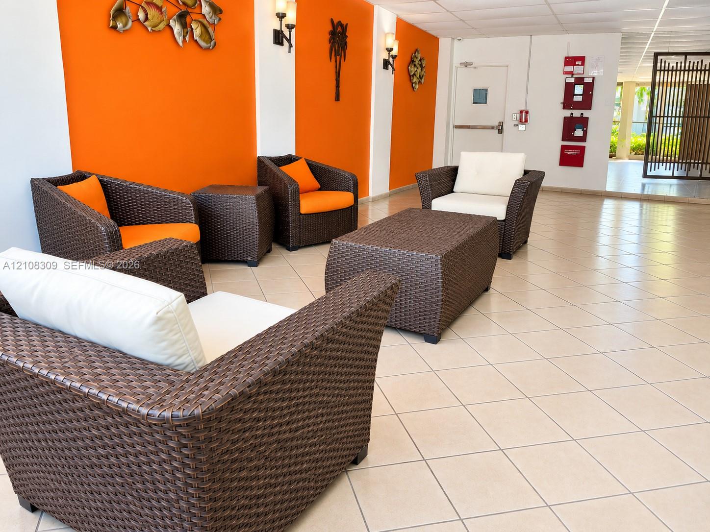 Common area featuring diagonal ceramic tile flooring, wall-mounted sconce lighting, and decorative wall accents Common area featuring diagonal ceramic tile flooring, wall-mounted sconce lighting, and decorative wall accents