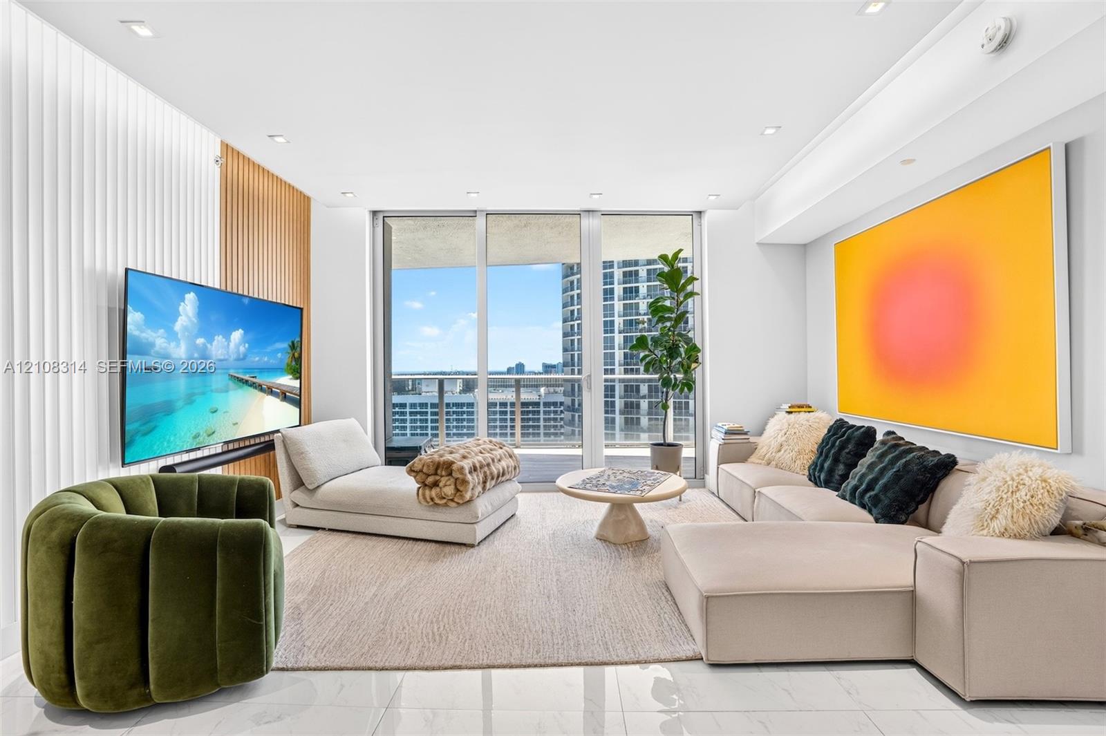 Living area featuring floor-to-ceiling glass windows, recessed lighting, white tile flooring, and a decorative wood-slat accent wall Living area featuring floor-to-ceiling glass windows, recessed lighting, white tile flooring, and a decorative wood-slat accent wall