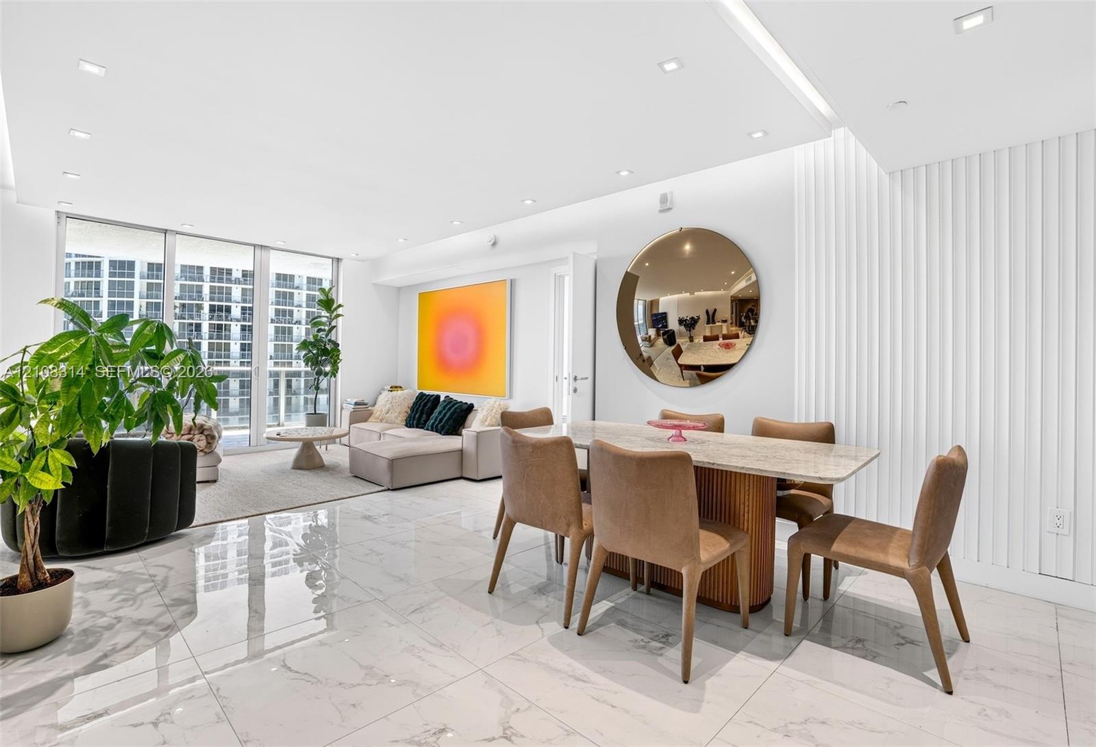 Large-format tile flooring, vertical wall paneling, recessed lighting, and floor-to-ceiling glass windows Large-format tile flooring, vertical wall paneling, recessed lighting, and floor-to-ceiling glass windows