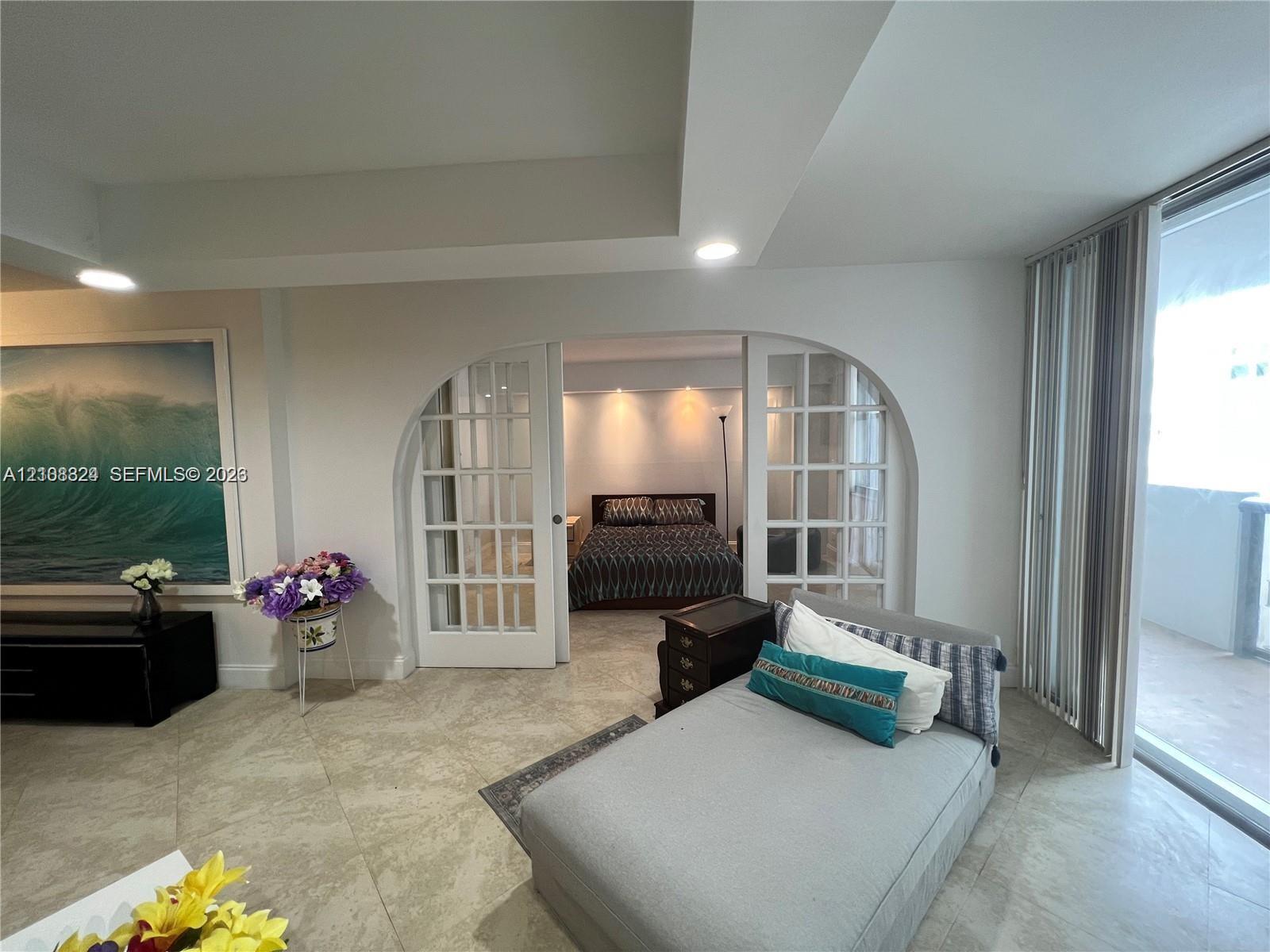 Interior space featuring large-format tile flooring, recessed ceiling lighting, and expansive sliding glass doors