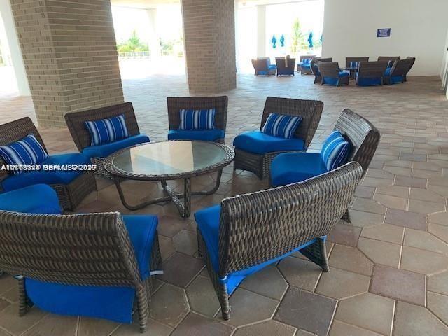 Covered patio featuring large-format stone pavers and structural masonry pillars
