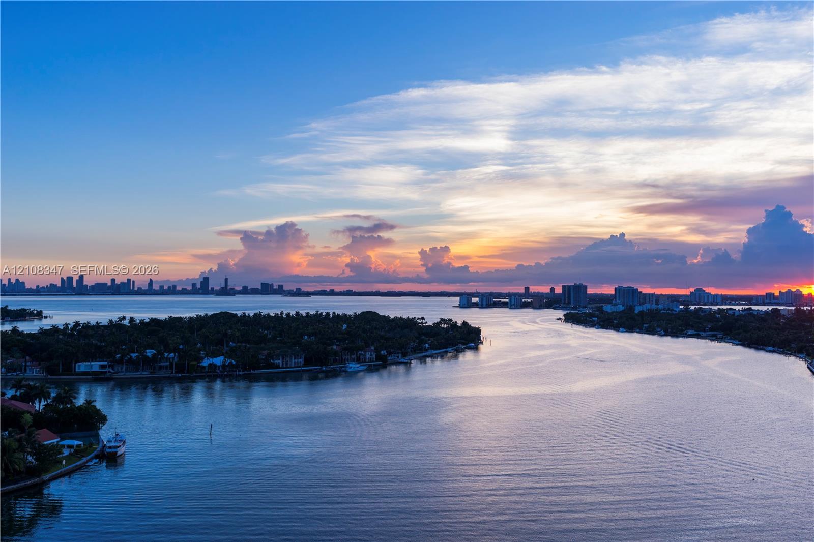 expansive bay views deep water access, skyline,open bayunder a sunset backdrop