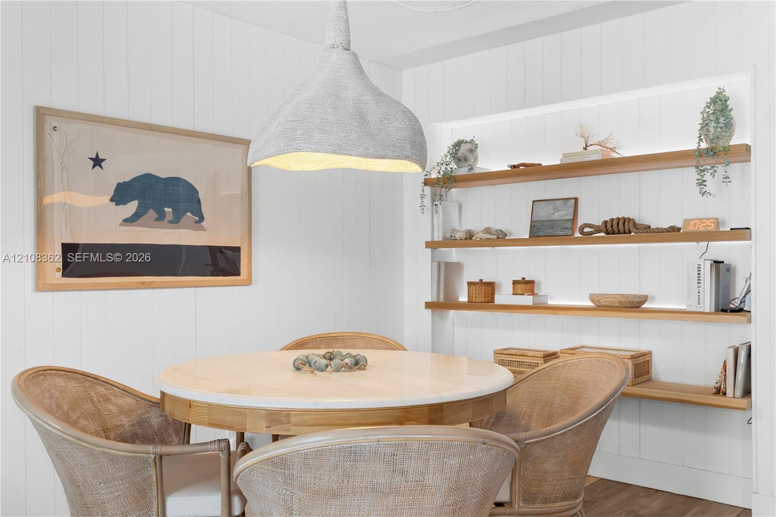 Built-in wall niche with recessed shelving, integrated linear lighting, and vertical plank wall paneling, complemented by a textured organic-form pendant light