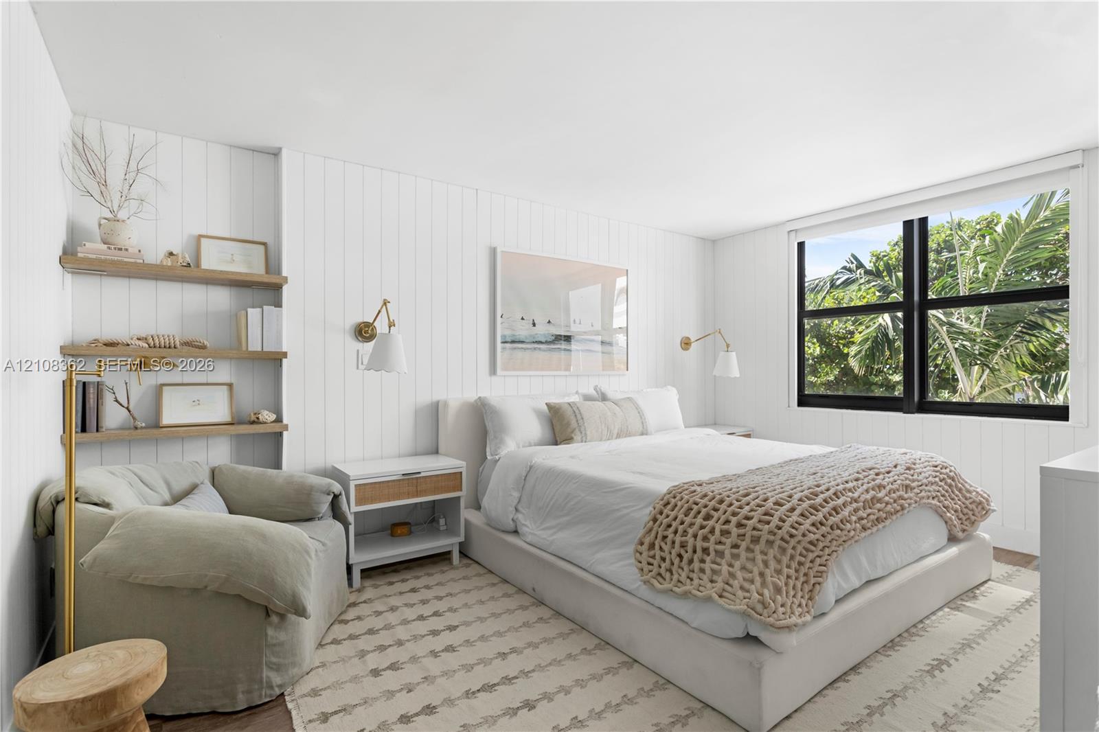 Vertical tongue-and-groove wall paneling, built-in recessed shelving, wall-mounted swing-arm light fixtures, and a multi-pane window