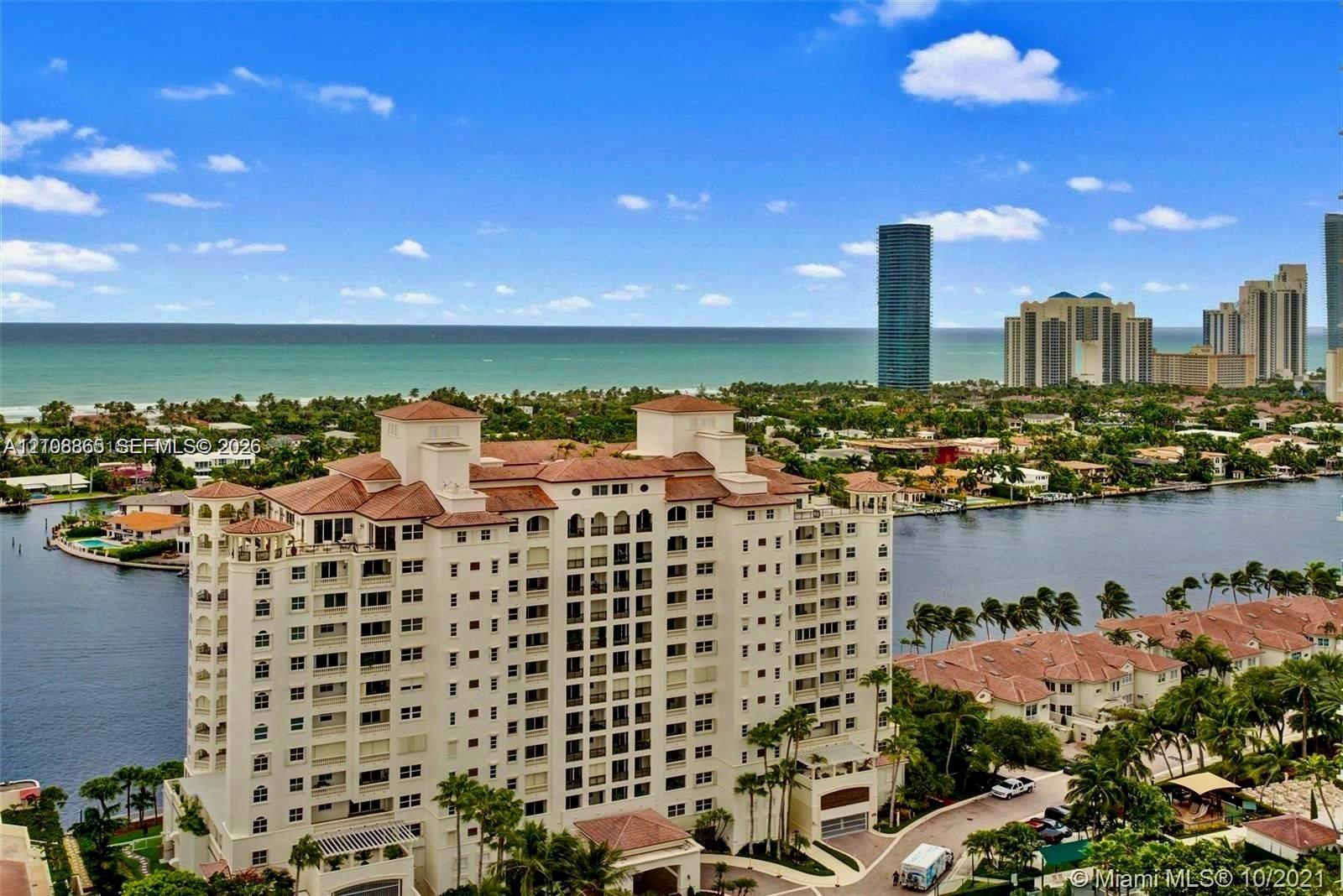 High-rise multi-story building featuring a red tile roof and arched architectural detailing, situated on a waterfront lot with canal access and coastal exposure High-rise multi-story building featuring a red tile roof and arched architectural detailing, situated on a waterfront lot with canal access and coastal exposure