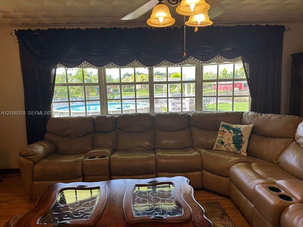 Large grid-style windows with multi-pane glass and a ceiling-mounted light fixture with three glass shades