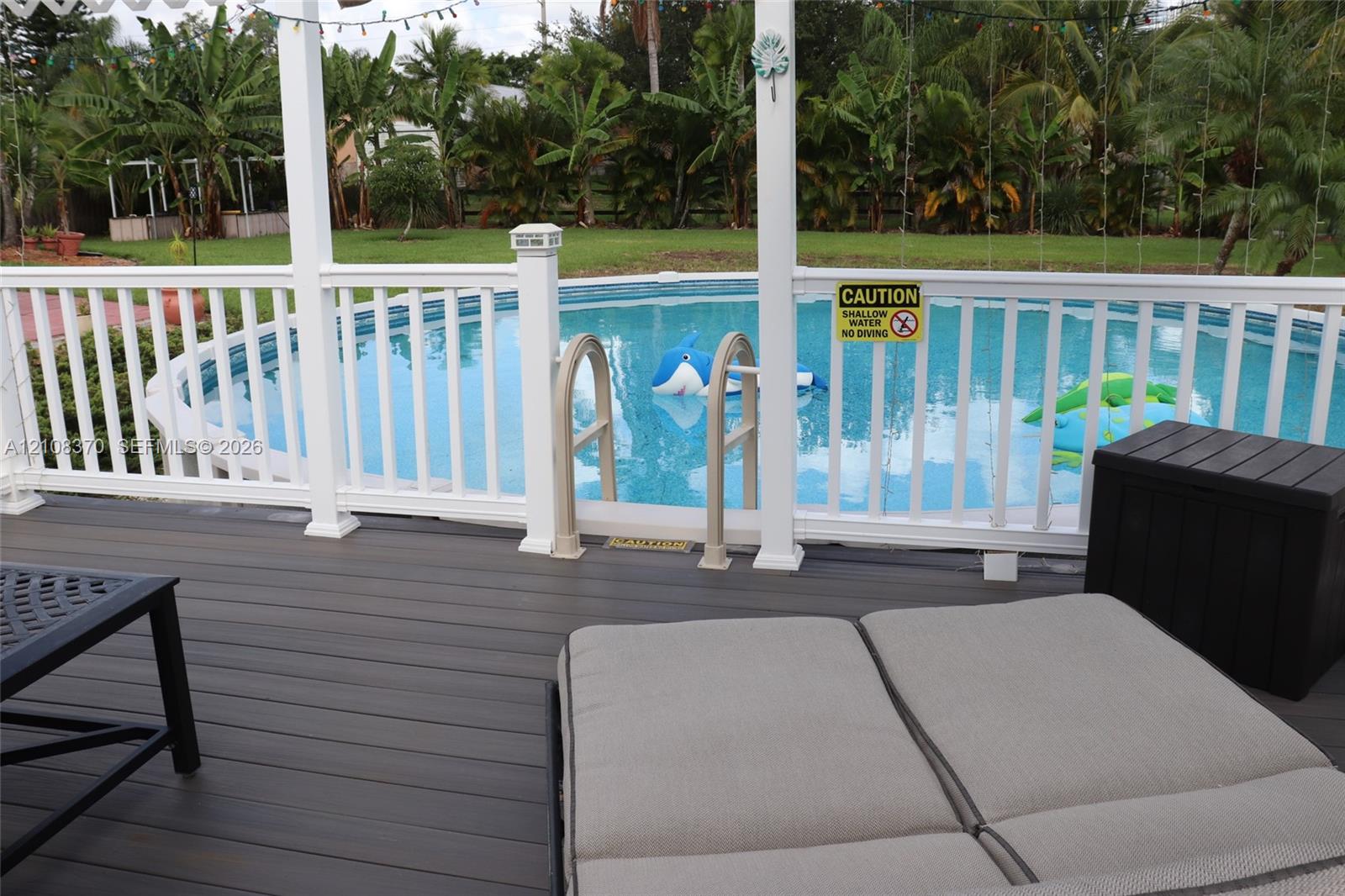 Composite deck featuring a white railing enclosure and a circular above-ground pool