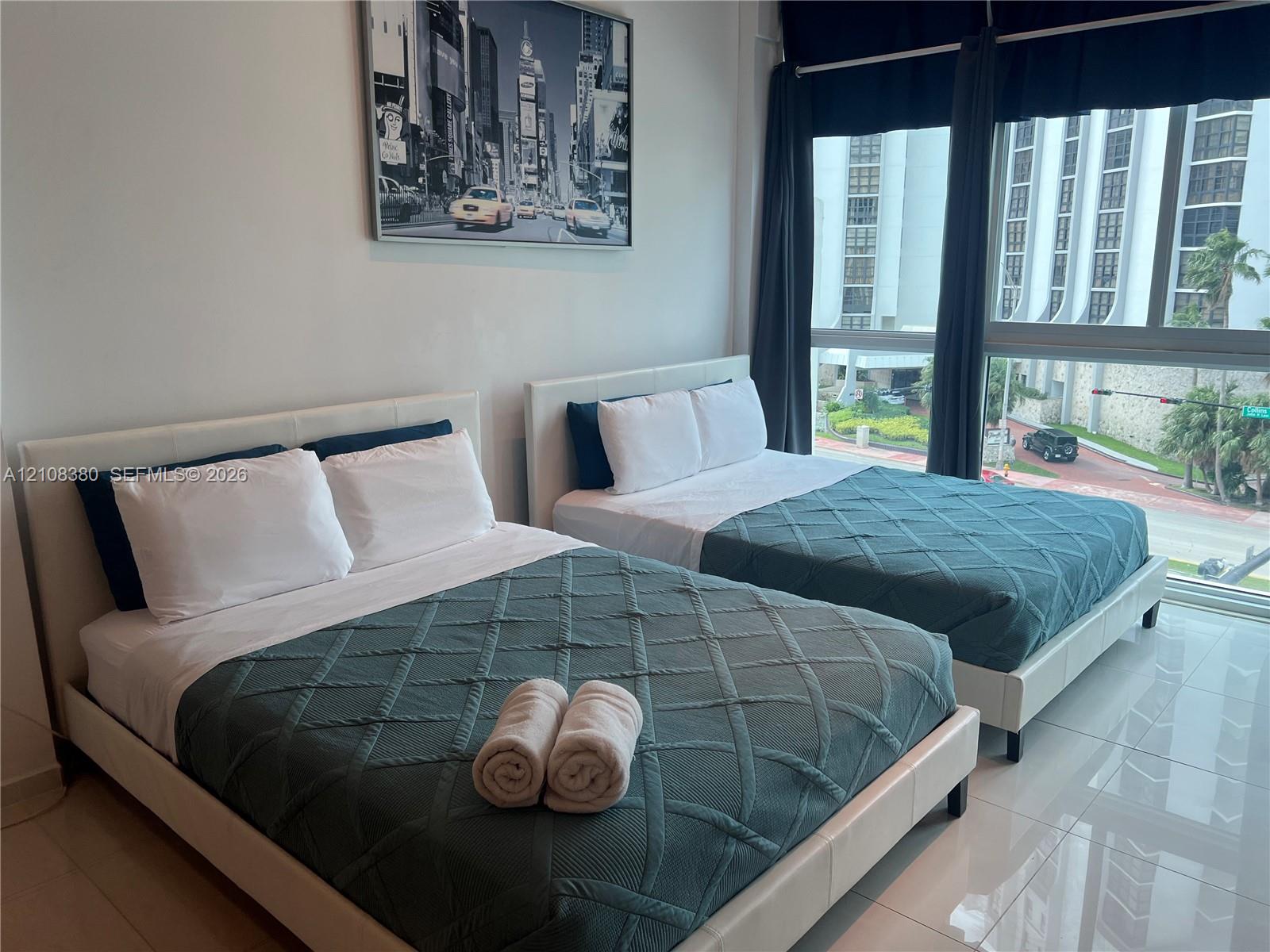 Floor-to-ceiling windows featuring expansive exterior exposure and polished tile flooring Floor-to-ceiling windows featuring expansive exterior exposure and polished tile flooring