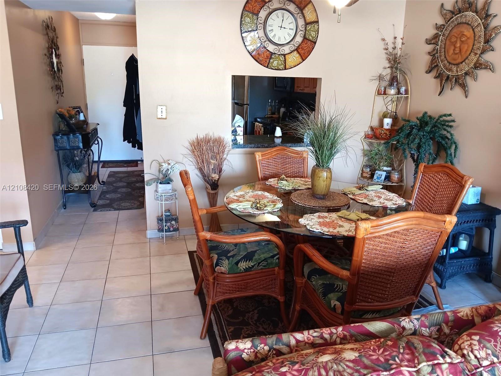 Ceramic tile flooring throughout and wall cutout featuring a stone-topped breakfast bar Ceramic tile flooring throughout and wall cutout featuring a stone-topped breakfast bar