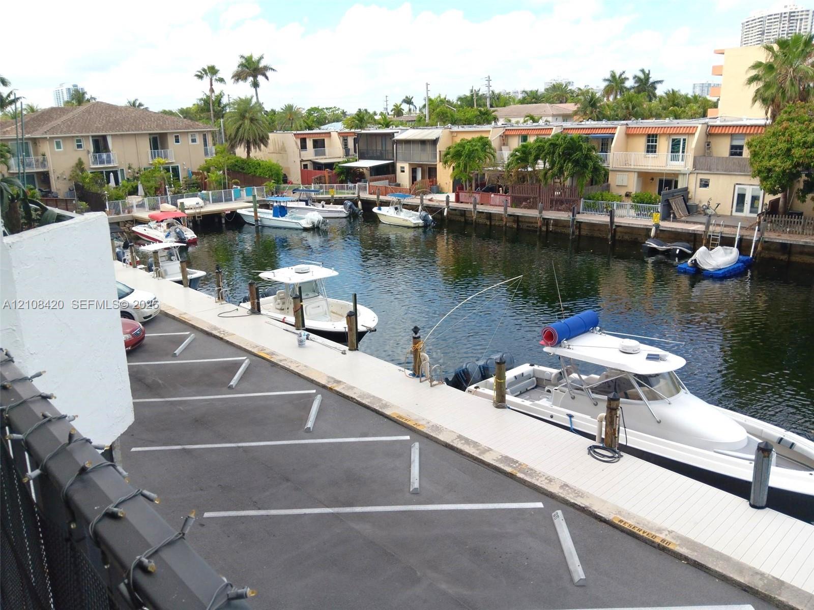 Waterfront property featuring a deep-water canal, private boat dockage, paved off-street parking, and concrete bulkhead