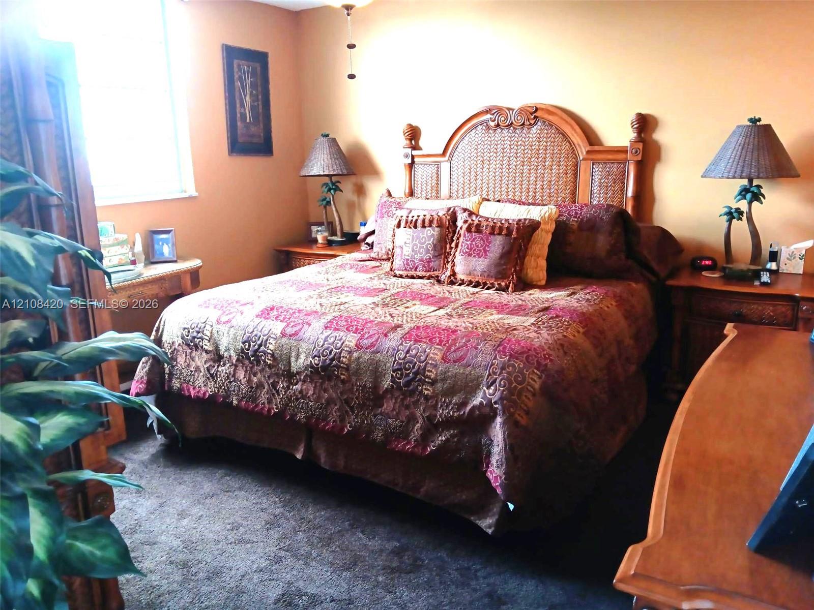 Bedroom featuring neutral wall paint, carpeting, and a multi-pane window