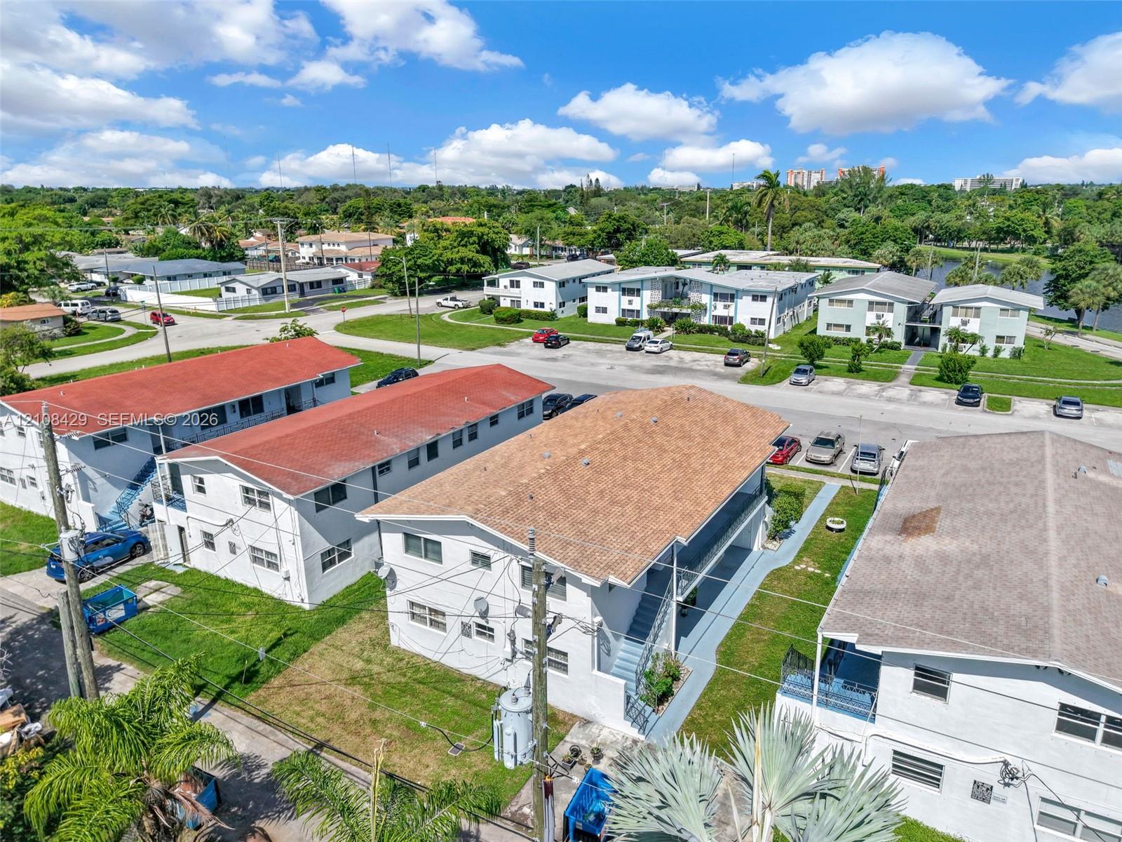 Multi-unit residential complex featuring shingled roofs, exterior staircase access, and dedicated surface parking