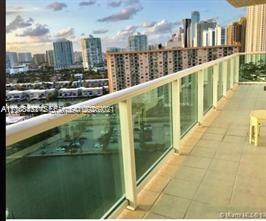 Private balcony featuring tile flooring and a glass-panel railing Private balcony featuring tile flooring and a glass-panel railing