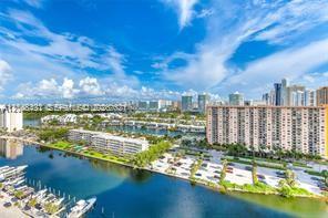 Aerial perspective of a waterway featuring boat slips, multi-story residential buildings, and surrounding urban infrastructure Aerial perspective of a waterway featuring boat slips, multi-story residential buildings, and surrounding urban infrastructure