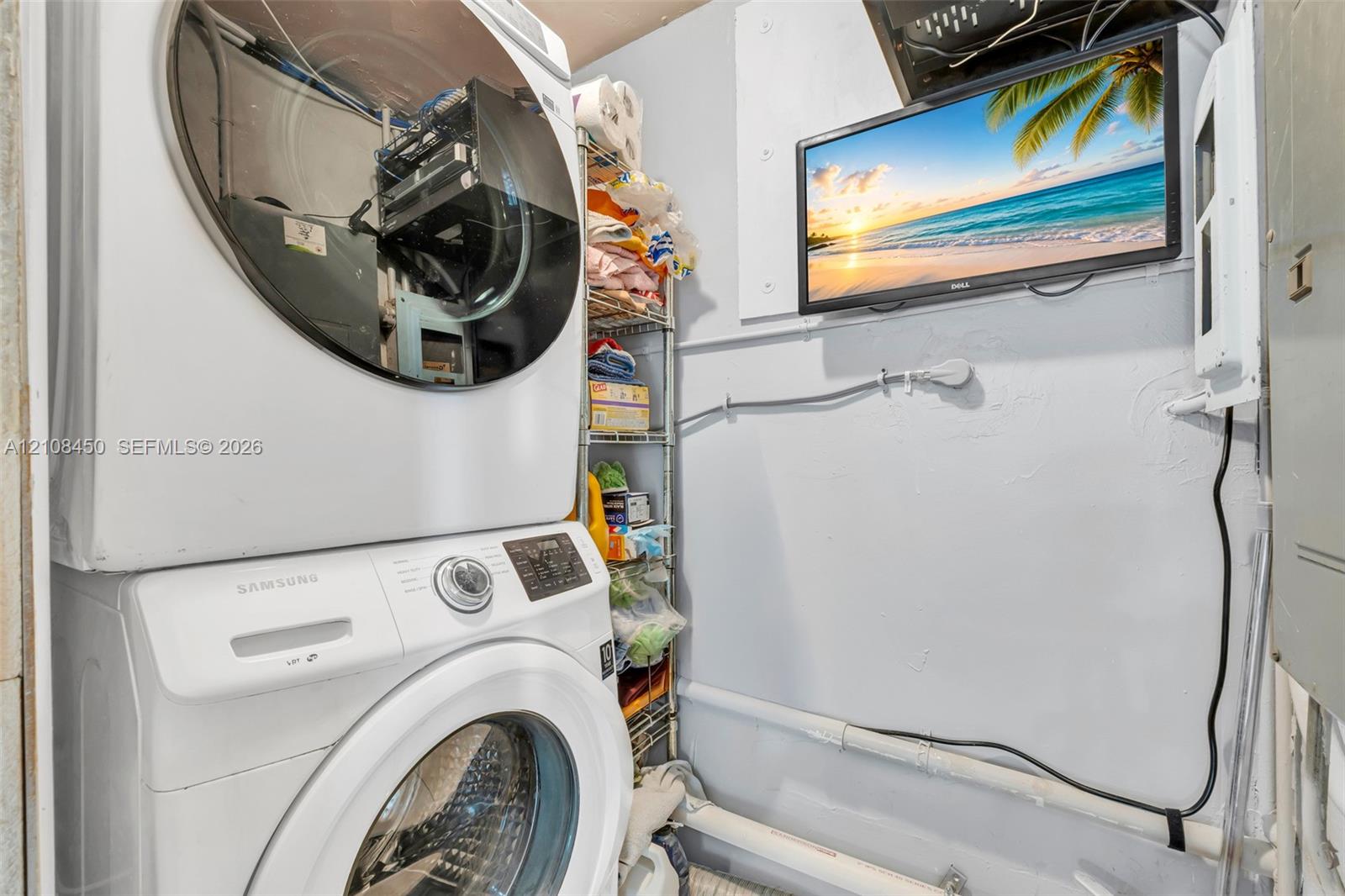 Stacked front-load laundry unit featuring a white finish