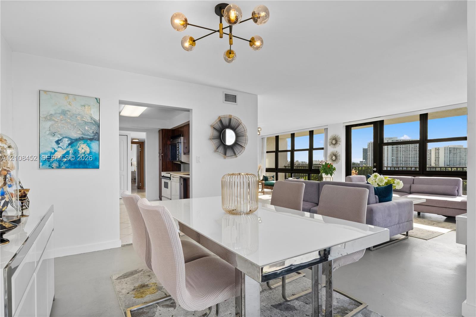 Modern multi-arm sputnik chandelier, floor-to-ceiling windows with external terrace access, and smooth-finish flooring