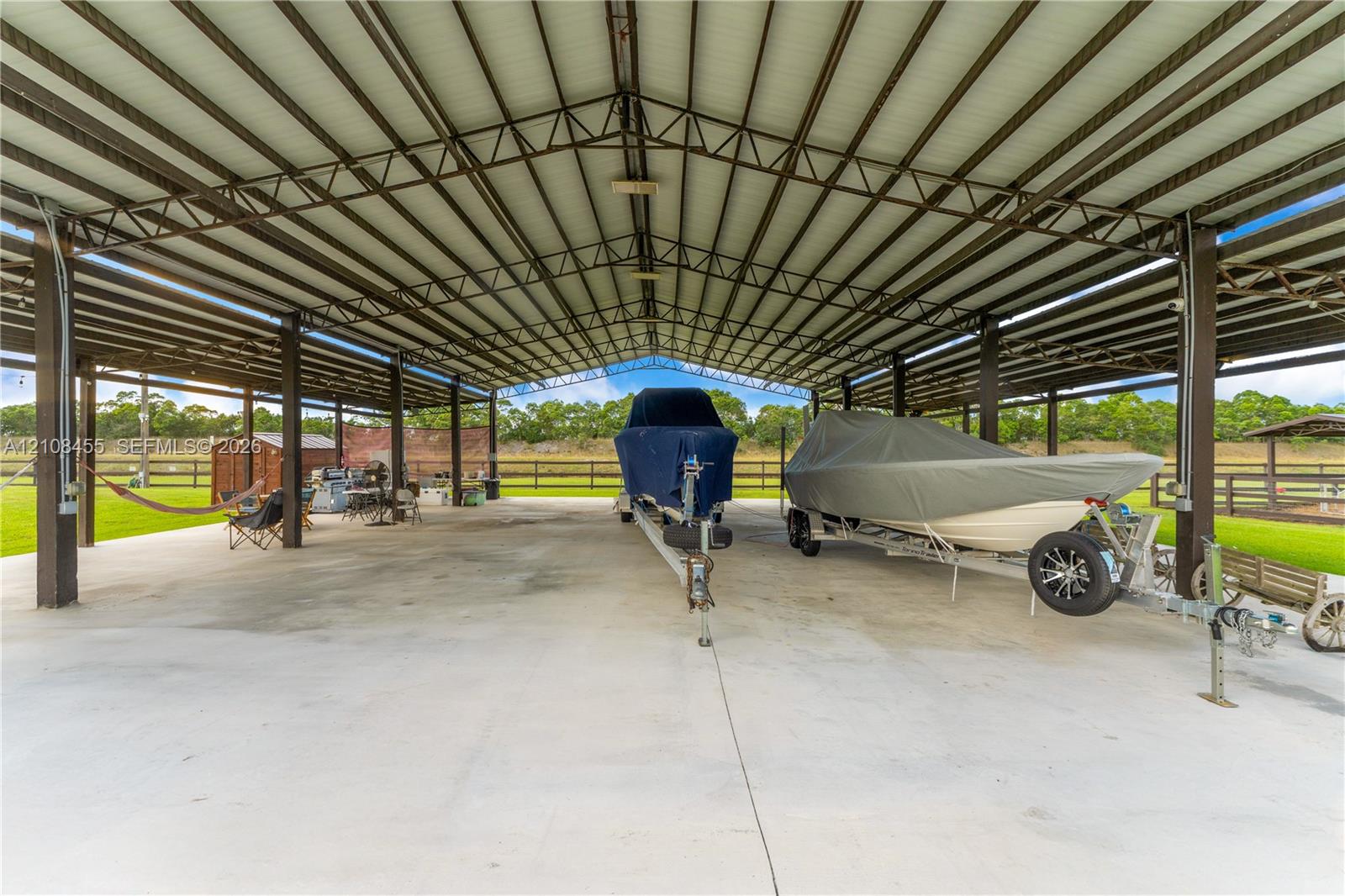 Expansive covered storage structure featuring a steel frame, high-clearance roof, and concrete slab flooring