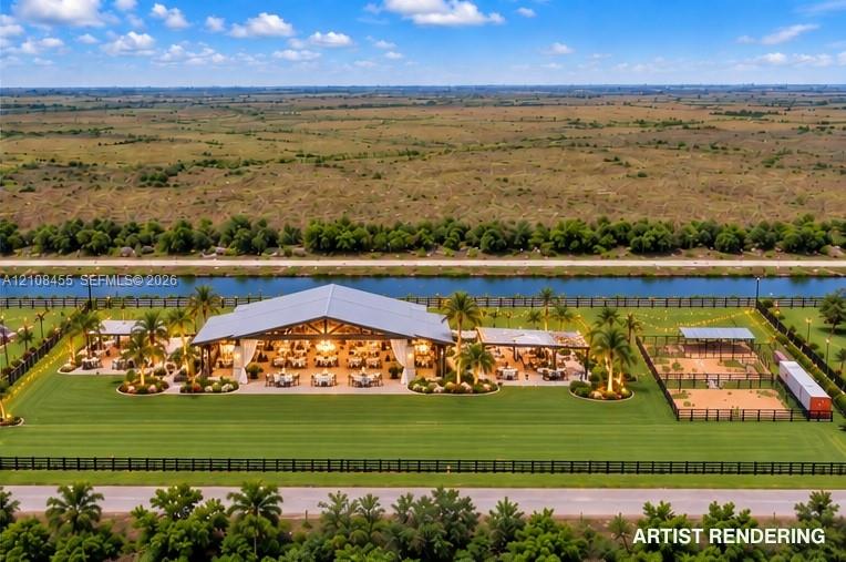 Expansive grounds featuring a metal-roofed open-air pavilion, manicured turf, multiple covered patio structures, and perimeter fencing, situated along a canal