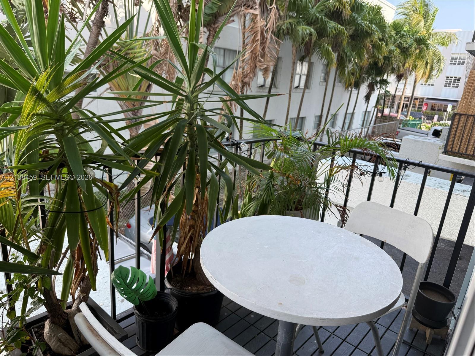 Outdoor balcony featuring black metal railings and slat-style flooring Outdoor balcony featuring black metal railings and slat-style flooring
