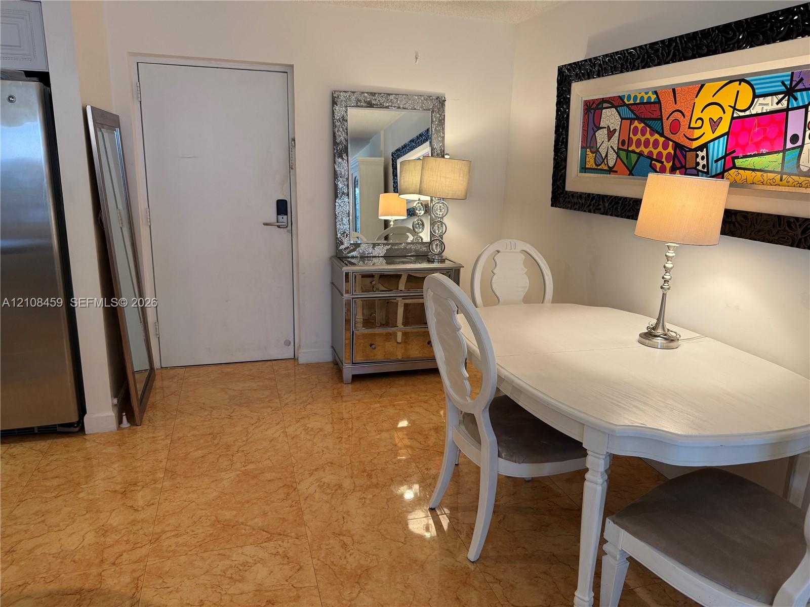 Polished stone flooring throughout the area and a high-contrast decorative wall accent Polished stone flooring throughout the area and a high-contrast decorative wall accent