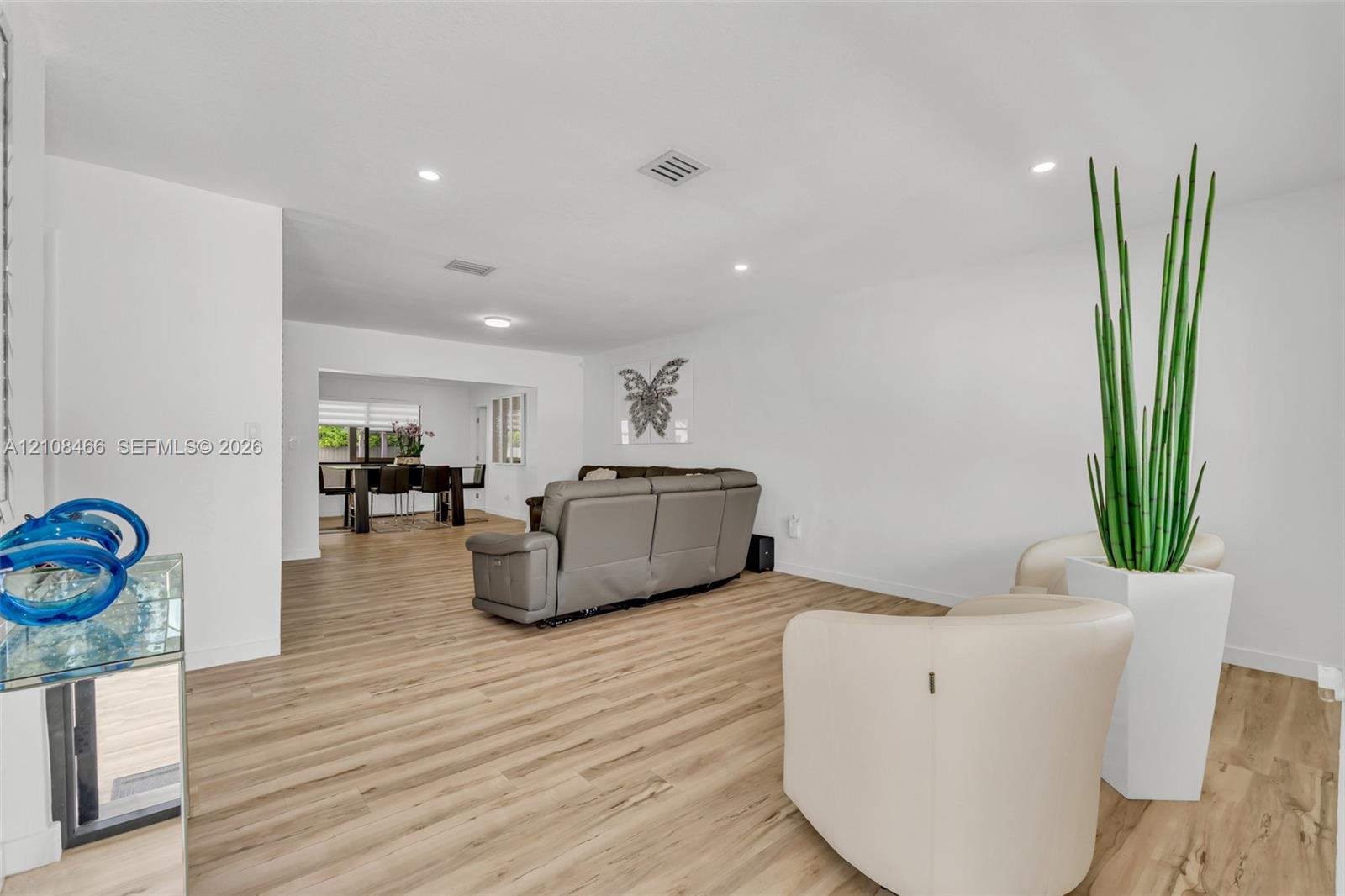 Open-concept interior featuring light wood-finish flooring and recessed lighting Open-concept interior featuring light wood-finish flooring and recessed lighting