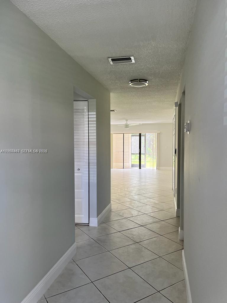 Entrance Hallway featuring neutral-toned walls, diagonal -format ceramic tile flooring, and integrated ceiling lighting