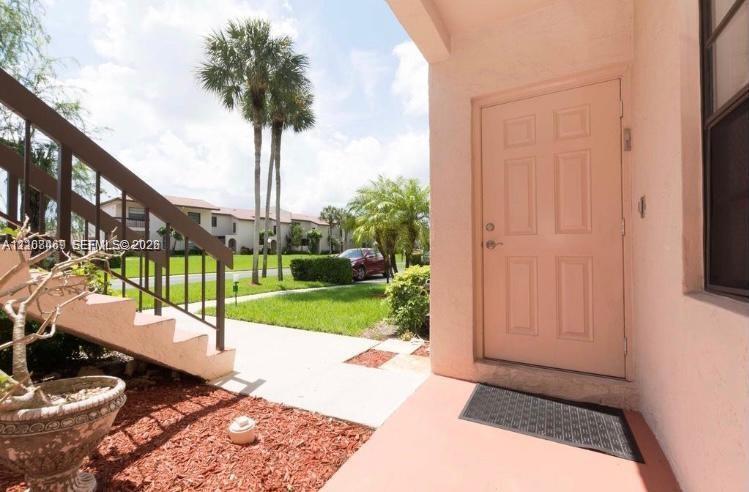 Covered entryway with a four-panel entry door