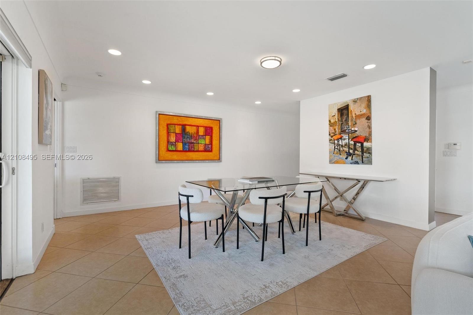 Neutral-toned tile flooring, recessed lighting, and a low-profile flush-mount ceiling fixture