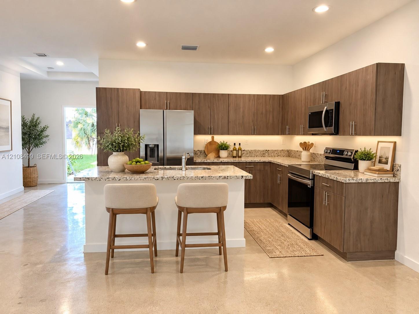 Kitchen featuring wood-finish cabinetry, stone-surface countertops, stainless steel appliances, under-cabinet lighting, and polished concrete flooring