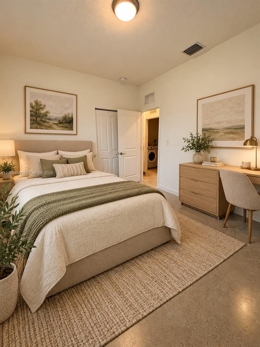 Neutral-toned room featuring polished concrete flooring, white walls, and a recessed ceiling light fixture
