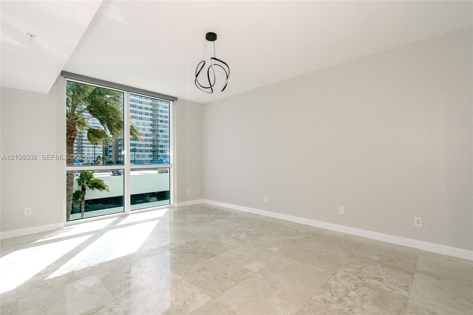 Floor-to-ceiling windows, polished stone flooring, and contemporary sculptural chandelier