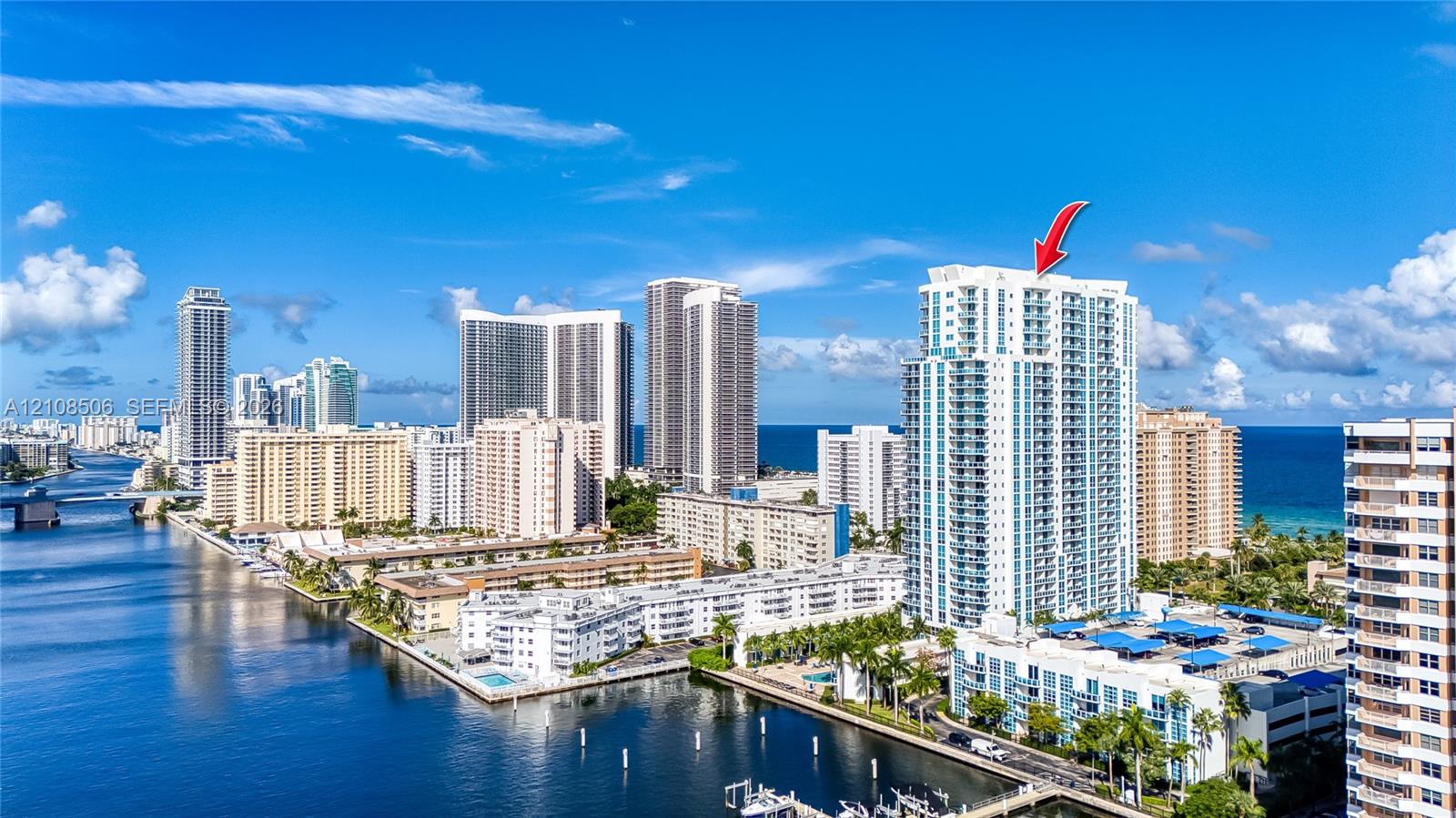 High-rise building featuring private balconies, floor-to-ceiling windows, and a waterfront location