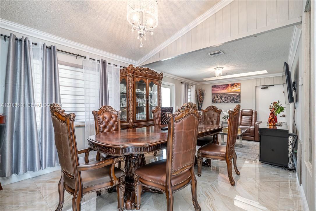 Polished stone flooring, vaulted ceilings, and decorative crystal chandelier Polished stone flooring, vaulted ceilings, and decorative crystal chandelier