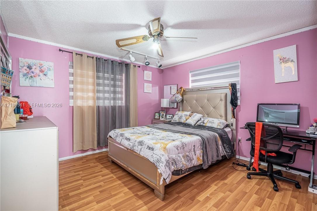 Wood-finish flooring, dual-track light fixture, and ceiling fan with integrated lighting Wood-finish flooring, dual-track light fixture, and ceiling fan with integrated lighting