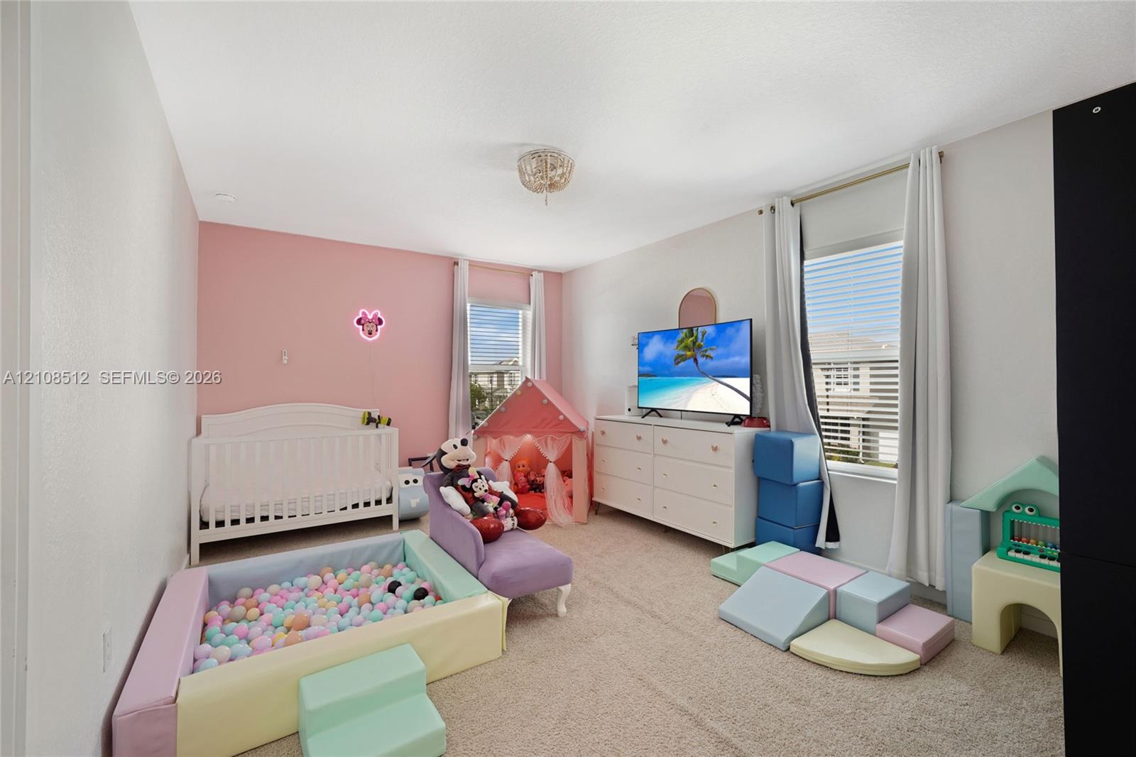 Neutral-toned carpeting, dual windows with natural light, and a flush-mount ceiling light fixture Neutral-toned carpeting, dual windows with natural light, and a flush-mount ceiling light fixture