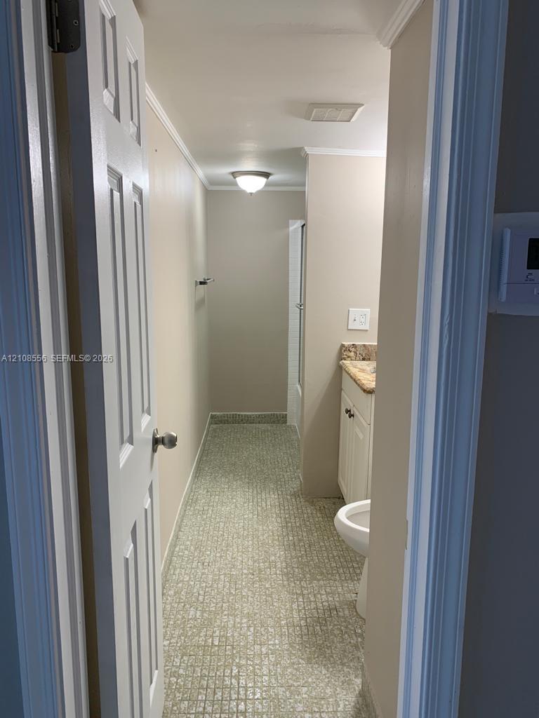 Bathroom featuring tiled flooring, stone-finish countertop, white cabinetry, and flush-mount ceiling lighting