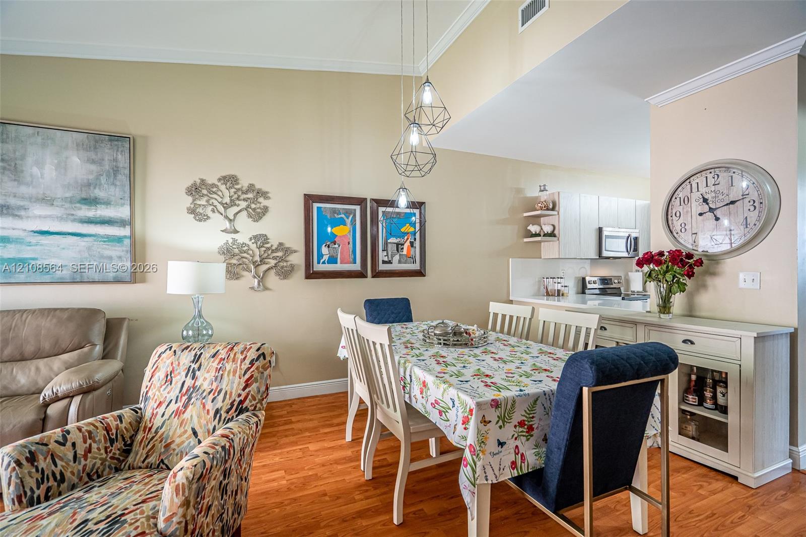Vaulted ceilings, wood-finish flooring, and geometric pendant lighting