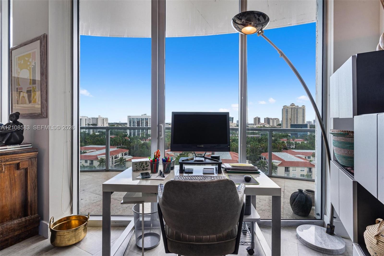 Floor-to-ceiling windows, glass balcony railing, and tile flooring
