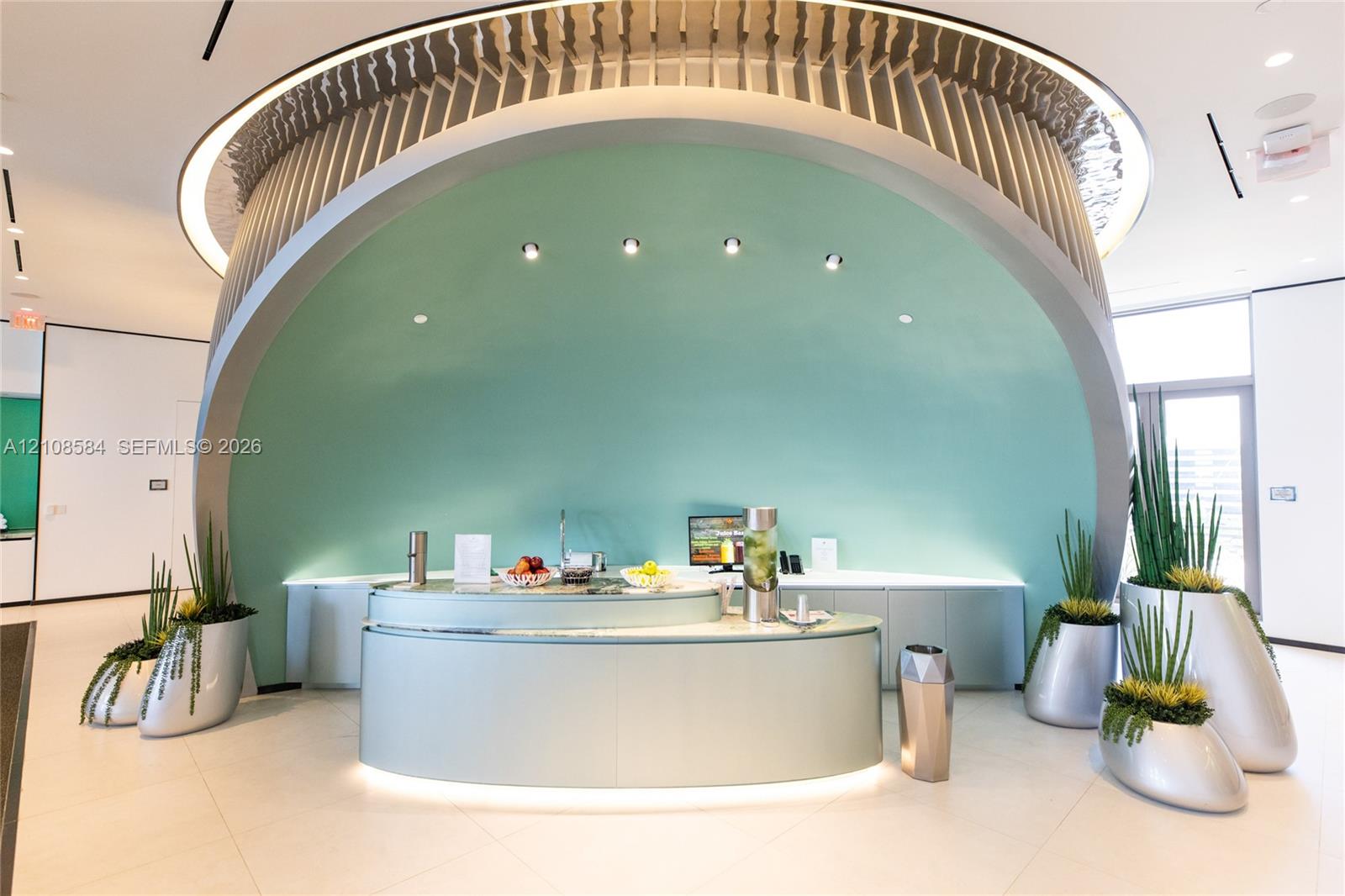 Custom arched architectural feature with integrated recessed lighting, curved reception counter, and large-format tile flooring