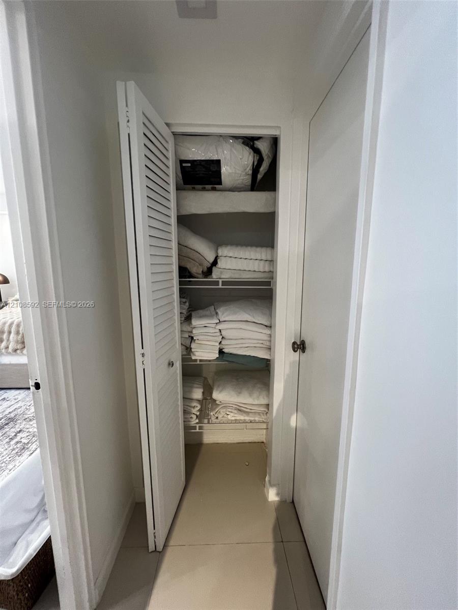 Storage closet featuring louvered bifold doors and integrated wire shelving