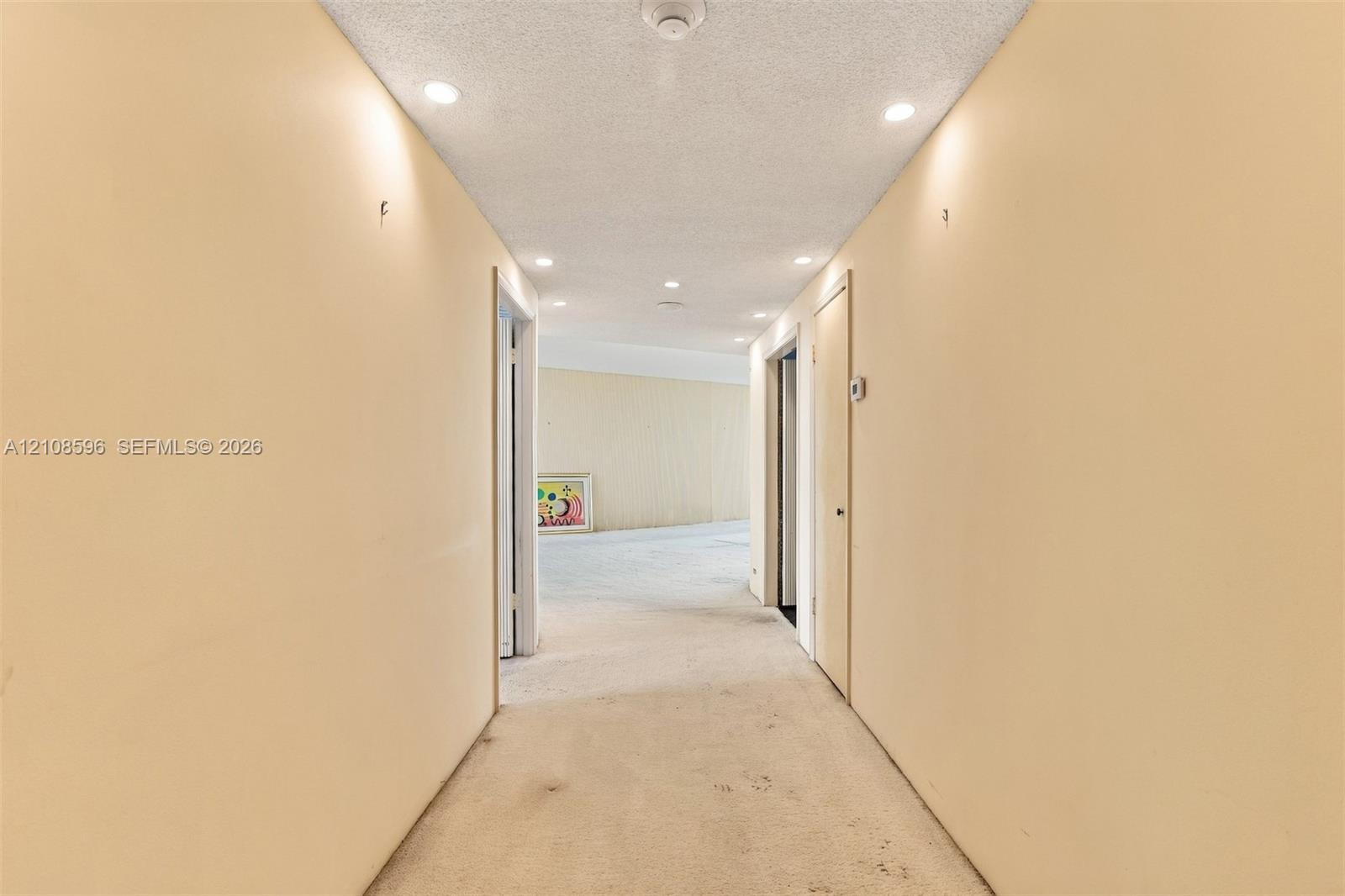 Hallway featuring recessed lighting and neutral-toned wall finish