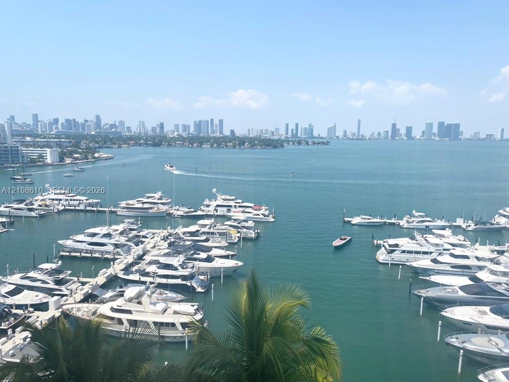 Panoramic waterfront perspective featuring a marina with multiple boat slips, deep-water access, and a prominent urban skyline backdrop Panoramic waterfront perspective featuring a marina with multiple boat slips, deep-water access, and a prominent urban skyline backdrop