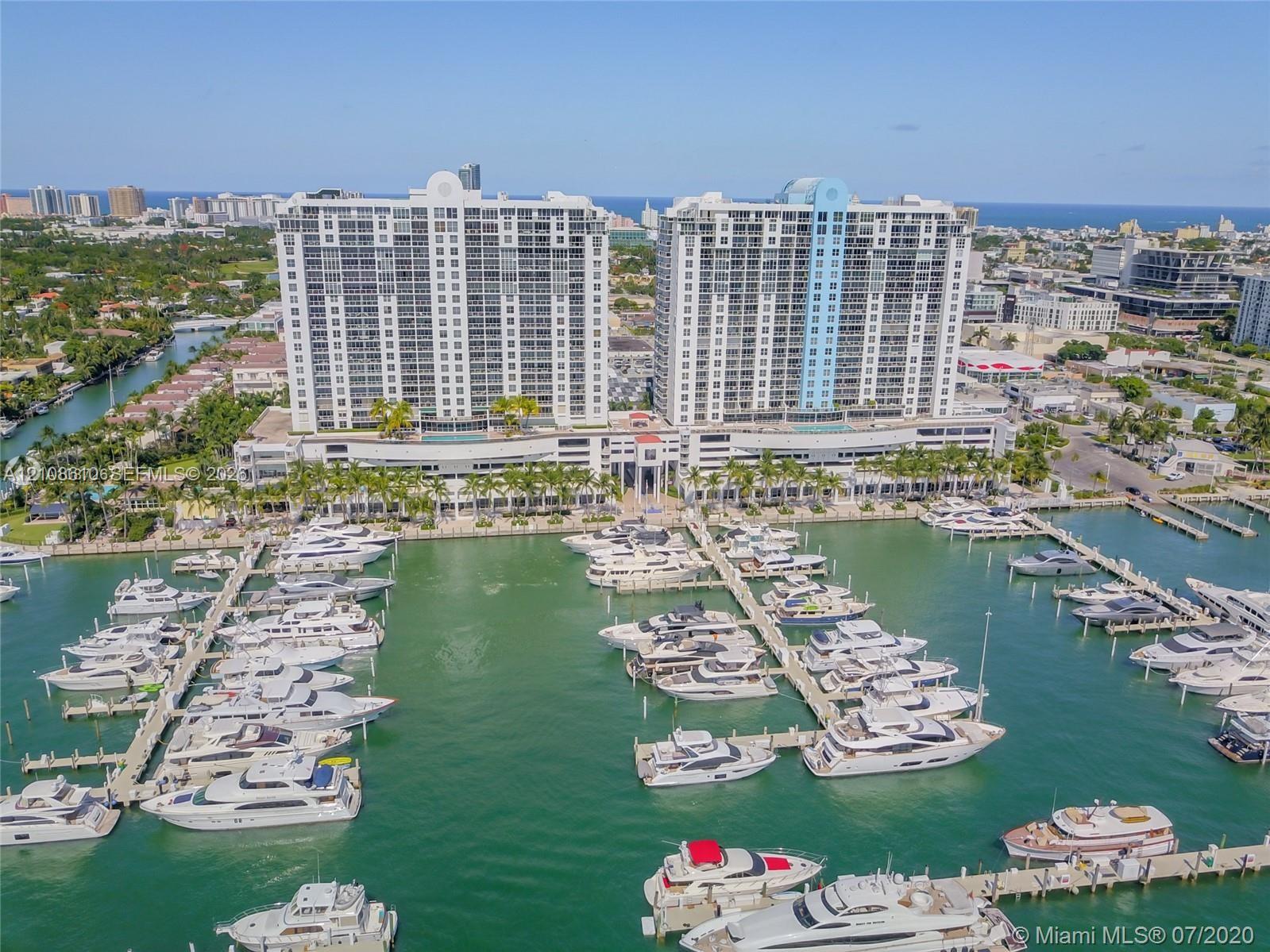 High-rise waterfront towers featuring deep-water marina access, private boat slips, and an elevated outdoor swimming pool