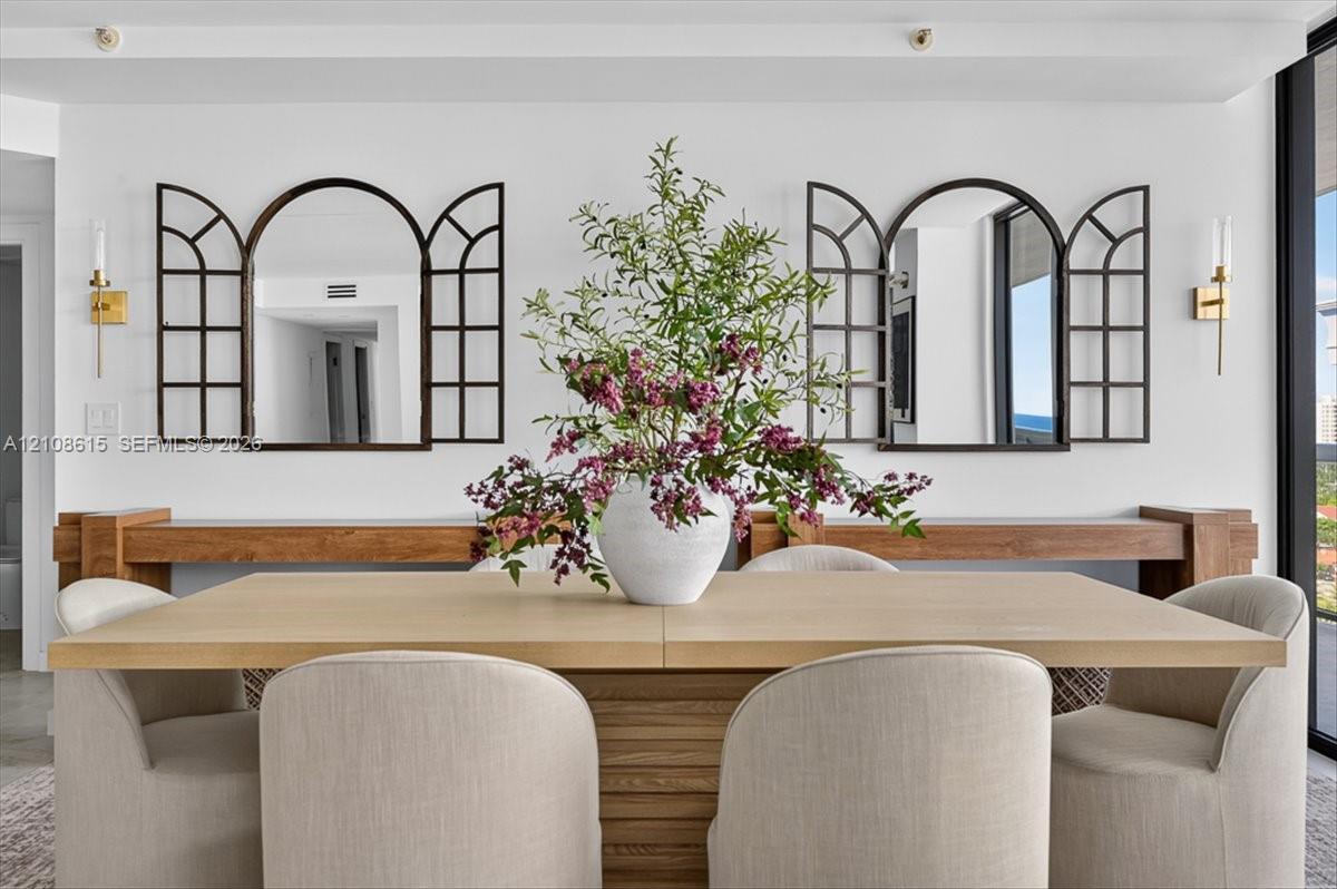 Custom wood wall-mounted consoles with two arched window-pane style decorative mirrors and dual metallic wall-mounted light fixtures
