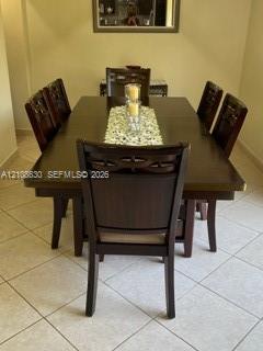 Neutral-tone ceramic tile flooring and wall-mounted mirror Neutral-tone ceramic tile flooring and wall-mounted mirror