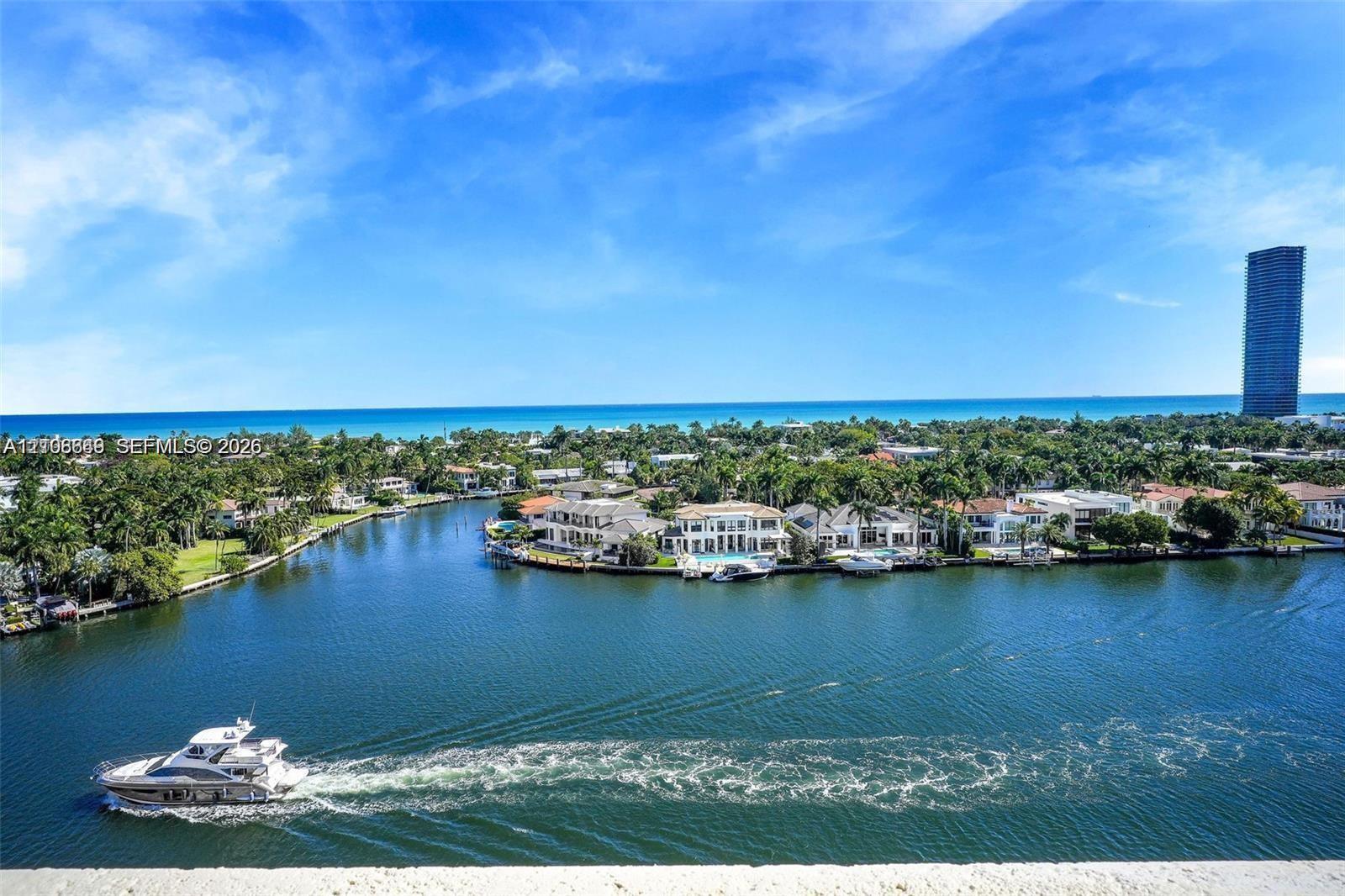 Panoramic waterfront location featuring deep-water canal access, mature landscaping, and an open horizon toward the ocean