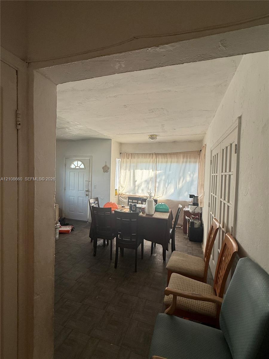 Tiled flooring, interior French doors with glass panes, and an exterior door with a decorative window insert Tiled flooring, interior French doors with glass panes, and an exterior door with a decorative window insert