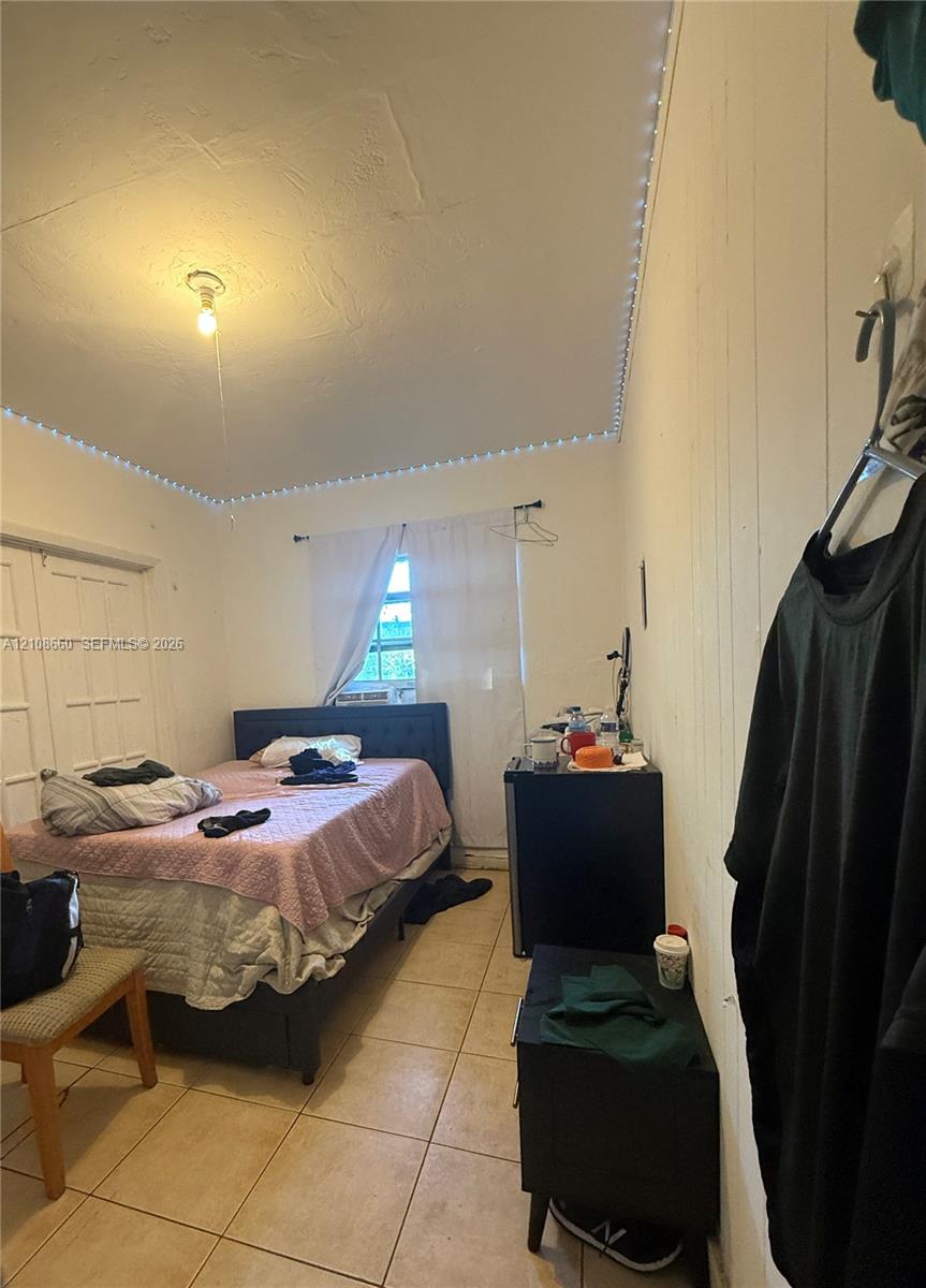 Ceramic tile flooring, paneled wall detailing, and double-door closet Ceramic tile flooring, paneled wall detailing, and double-door closet